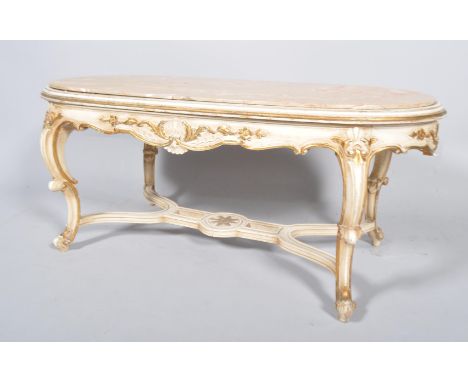 A Louis XV style parcel-gilt carved wood and marble oval sofa table, 20th century, carved with shells, flowers and acanthus s