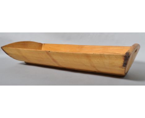 A 20th century beech dough trough/trugg, having a dished rectangular form with recessed handles to sides, 19cm x 96cm x 49cm