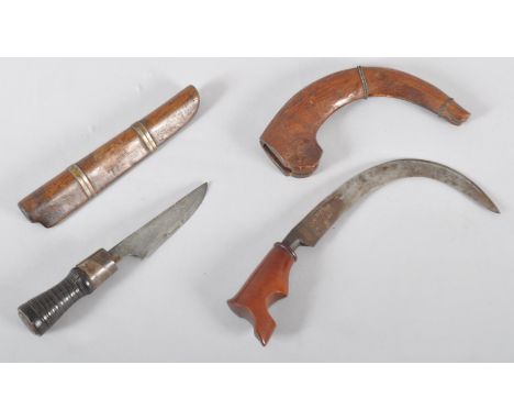 A Middle Eastern day knife with ebony grip and round hardwood scabbard, 12cm long, and another, probably Indonesian, with car