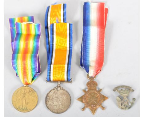 Three World War I medals and a cap badge, comprising : The Victory medal, the 1914-15 Star medal; the British War medal, each