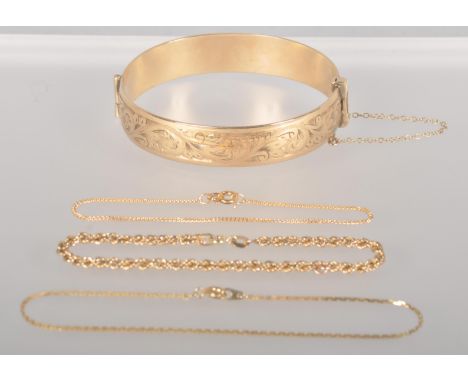 A collection of jewellery to include: A rolled gold half engraved bangle; Three 9ct gold bracelets of variable designs. Gross