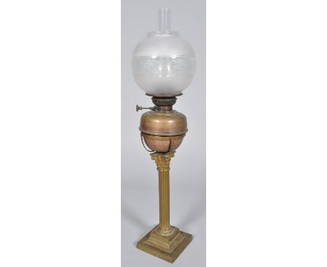 A large brass and copper fluted Corinthian column oil lamp with acid etched globe shade, 80cm high