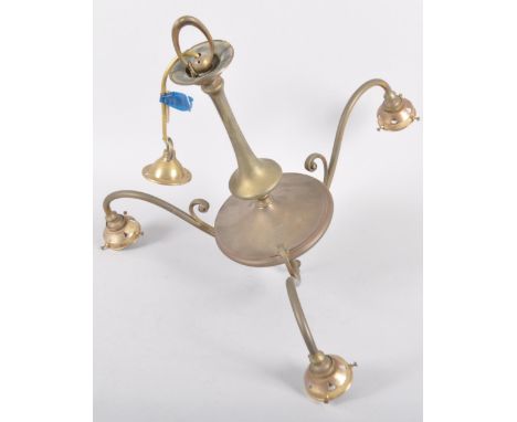 An Edwardian brass three light candelabra, early 20th century, with three s-shaped scroll branches issuing pierced scones, su