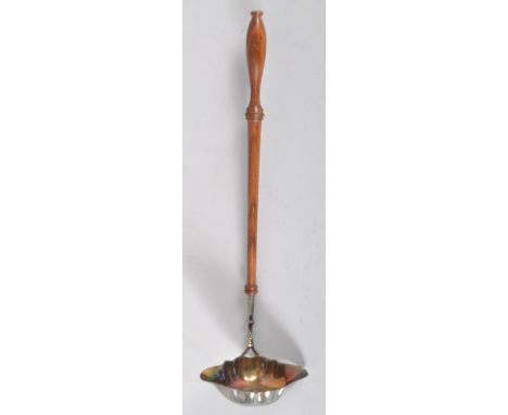 A silver punch or toddy ladle, with shaped oval double lipped bowl, set on a turned mahogany handle, London 1992, 32cm high, 