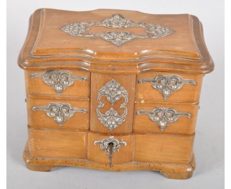 A Continental mahogany commode shaped trinket box, late 19th century, of serpentine outline with silver coloured foliate moun