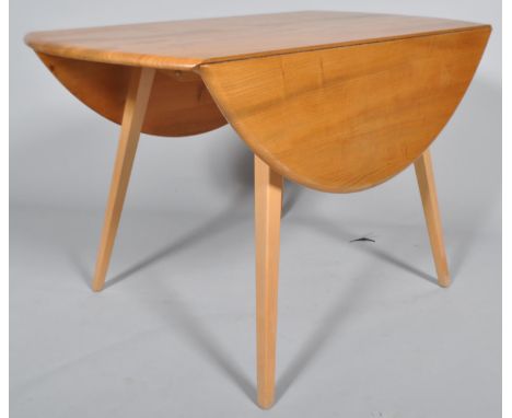 Lucian Ercolani - Ercol - 384 - A 1960's retro vintage beech and elm round drop leaf dining table, all raised on angled taper