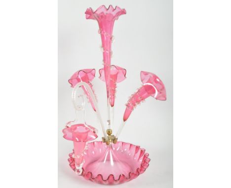 A Victorian cranberry glass epergne, late 19th century, the central fluted well with gilt metal mount, issuing trumpets, with