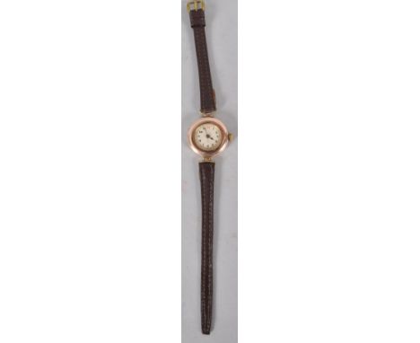 A yellow gold cased Rolex wristwatch. Champagne circular numerical dial. Manual wind movement, signed Rolex 15 jewels. Case r