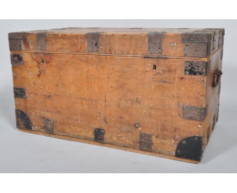 A pine and studded metal mounted travelling trunk, with carrying handles, the hinged top named in black script for 'NE Parry/