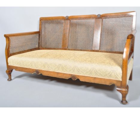 A 1930's art decor walnut and bergere cane work sofa suite comprising of a pair of armchairs and a sofa, sofa measures 81cm x