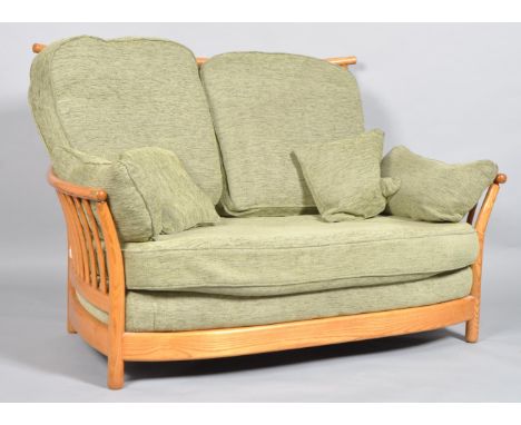 An Ercol Renaissance Gold Dawn tow seater sofa, with high back, a bentwood curved top rail and stick back and sides, the drop