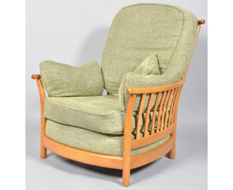 An Ercol Renaissance Golden Dawn armchair, with high back, a bentwood curved top rail and stick back sides, the cushions upho