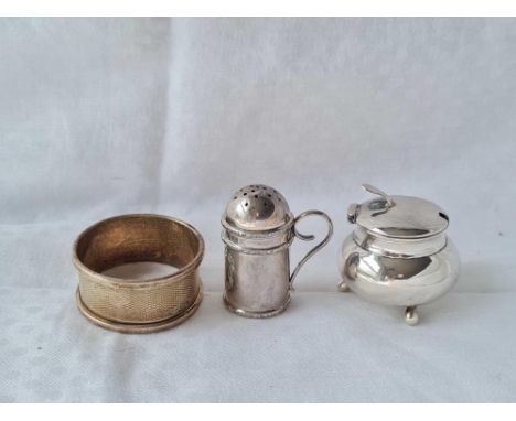 A small cauldron shaped mustard pot, a kitchen pepper and a napkin ring 