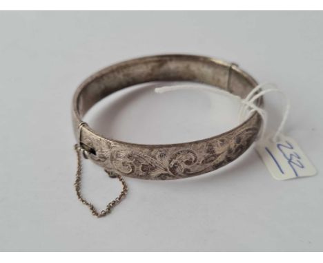 A engraved hinged silver bangle 