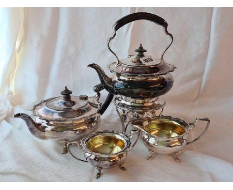 A four piece tea  set with kettle on stand