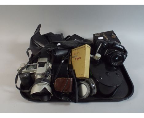 A Tray Containing Three 35mm Cameras, Box Camera, Movie Camera and Accessories