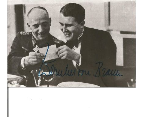 Space and Rocket pioneer Wernher Von Braun signed 5 x 3 b/w photo sitting with a General looking at a photograph in evening d