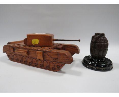 A NOVELTY TREEN BOX IN THE FORM OF A TANK TOGETHER WITH A FIRST WORLD WAR HAND GRENADE INKWELL