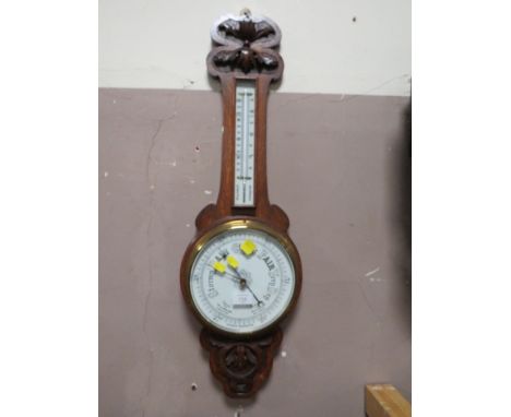 A VINTAGE CARVED OAK BAROMETER
