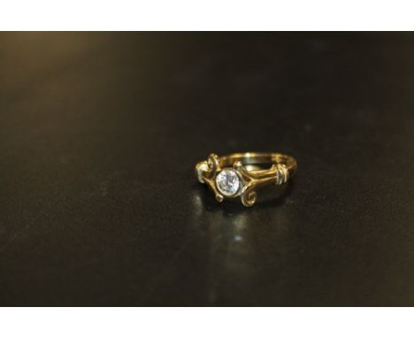 A HALLMARKED 18 CARAT GOLD HALF CARAT DIAMOND RING, in an unusual split swirl band setting, the insurance certificate stating
