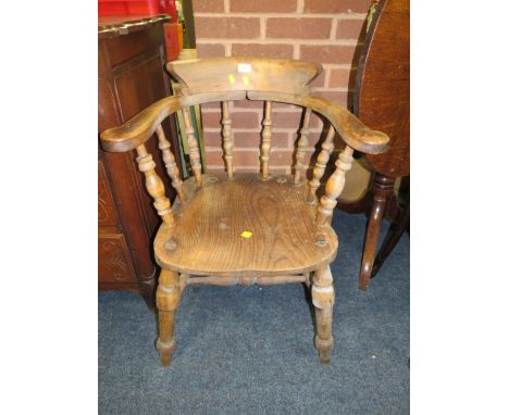 AN ANTIQUE SMOKERS BOW ARMCHAIR