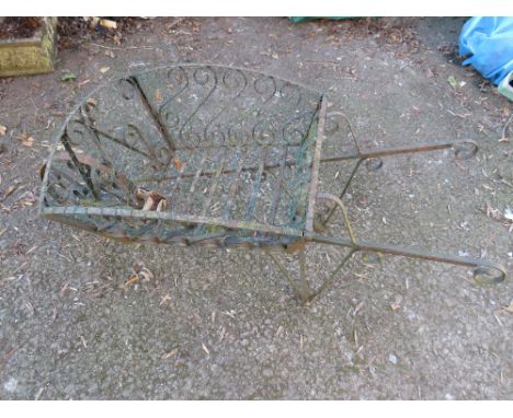 A WROUGHT IRON DECORATIVE PLANTER DEPICTING A WHEELBARROW