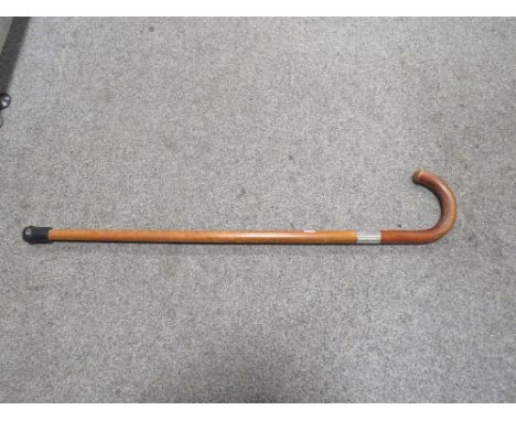 A MALACCA WALKING STICK WITH HALLMARKED SILVER BANDING