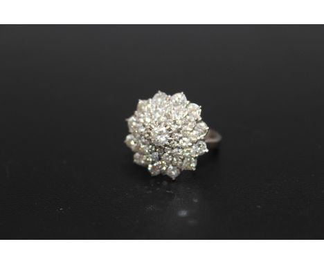 A HALLMARKED 18 CARAT WHITE GOLD DIAMOND CLUSTER RING, set with five rows of brilliant cut diamonds totaling an estimated 2.5