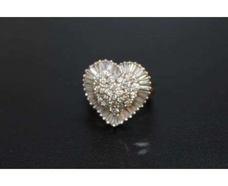 A HALLMARKED 18 CARAT GOLD HEART SHAPED DIAMOND CLUSTER RING,  set with a combination of baguette and brilliant cut diamonds 