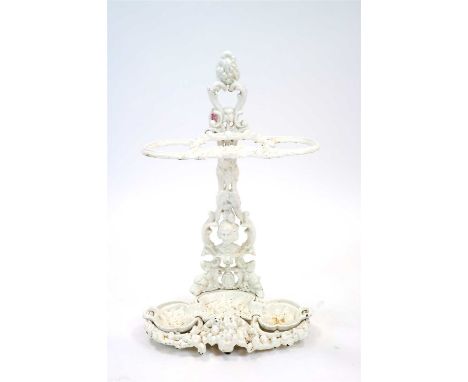 A Victorian cast iron hall stick / umbrella stand, the scrolling pierced back centred by a detailed figural bust mask before 