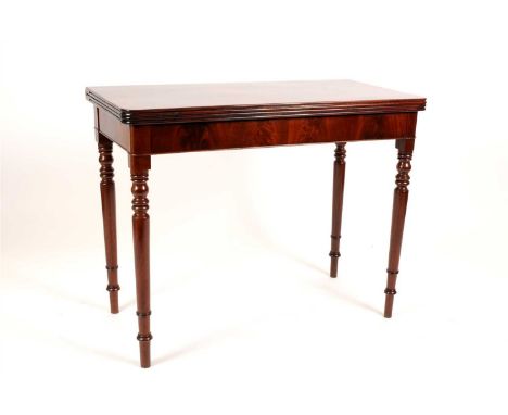 A mahogany sliding card / tea table, the hinged rounded rectangular top with fluted borders opening over four tapering turned