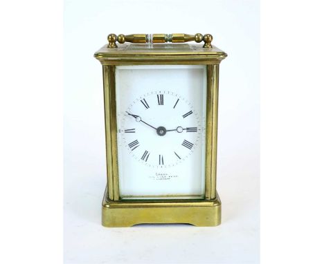 A small brass cased carriage clock, the white enamelled dial with black Roman numerals, set in bevelled glass plates, 13 cm h