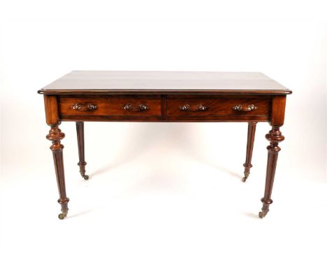 A Victorian flame satinwood veneered side table with a rounded rectangular top above two frieze drawers with carved scrolling