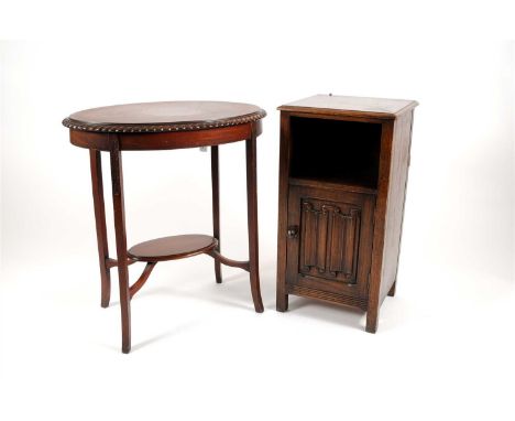 An oak bedside cupboard with a bevelled squared top above a vacant compartment and linen-fold carved panelled door by Waring 