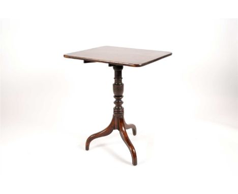 A George III country oak snap-top table, the rounded rectangular tablet top raised on a turned stem above three swept sabre l