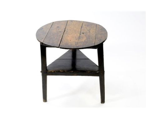 An oak cricket table, first half 19 th century, reconstructed, the oval five plank top on a triangular frame with square tape