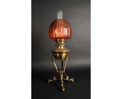 Attributed to WAS Benson, a brass framed desk oil lamp stand, on three swept supports, accommodating a brass fount with a Mes