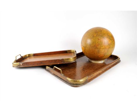 A graduating pair of Edwardian brass-capped oak trays, each of rounded rectangular form, with polished brass collars and loop