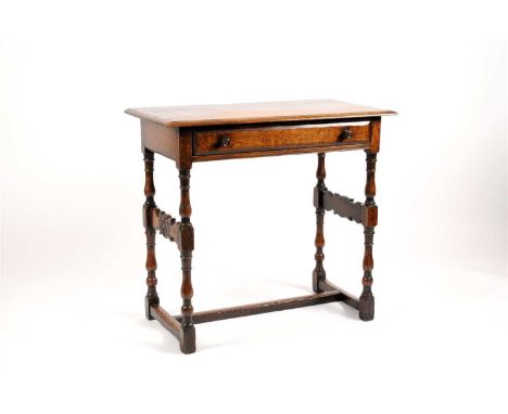 A George III rustic country style oak side / hall table, the bevelled rectangular top above a single long frieze drawer fitte