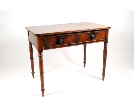 A Victorian mahogany side table, the rounded rectangular top with a fluted border above two frieze drawers in flamed veneers 