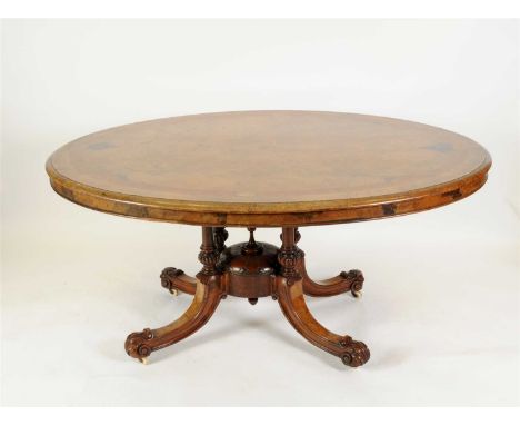 A Victorian walnut veneered breakfast table, the oval top veneered principally in burr walnut, border in amboyna with further