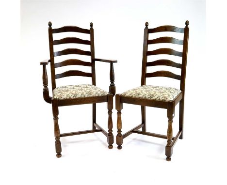 A set of six reproduction oak ladder back dining chairs, comprising four chairs and two carvers, all with shaped slatted ladd