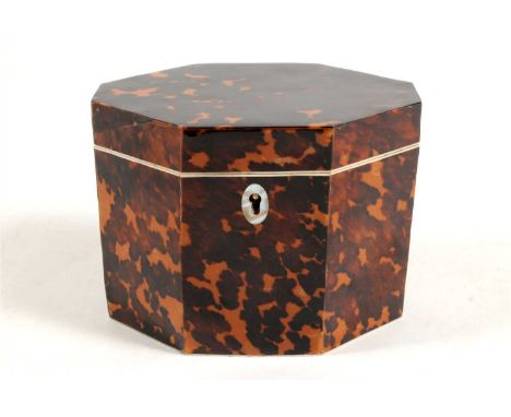 A faux tortoiseshell tea caddy in George III style of hexagonal form, with inner lid and lined interior