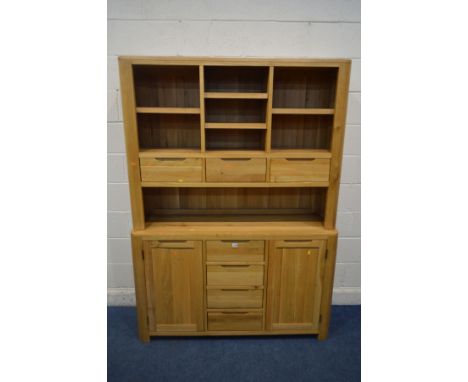 A LIGHT OAK DRESSER with an assortment of shelves, drawers and led lighting, above a base with two cupboard doors, width 139c
