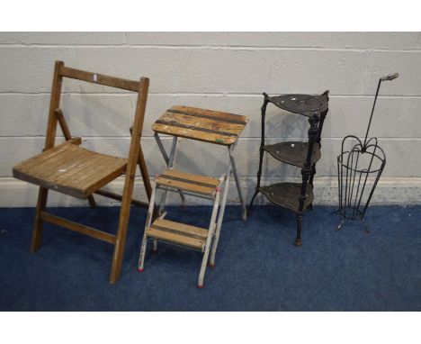 A BLACK PAINTED CAST IRON THREE TIER STAND, along with a metal umbrella stand, a folding beech chair and a folding metal step