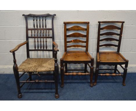 A PERIOD OAK SPINDLE BACK COUNTRY ELBOW CHAIR, with a rush seat (Sd) along with a near pair of oak ladder back chairs and ano