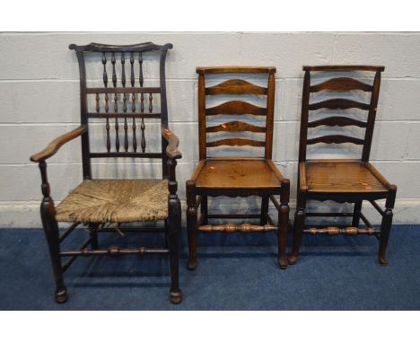 A PERIOD OAK SPINDLE BACK COUNTRY ELBOW CHAIR, with a rush seat (Sd) along with a near pair of oak ladder back chairs and ano