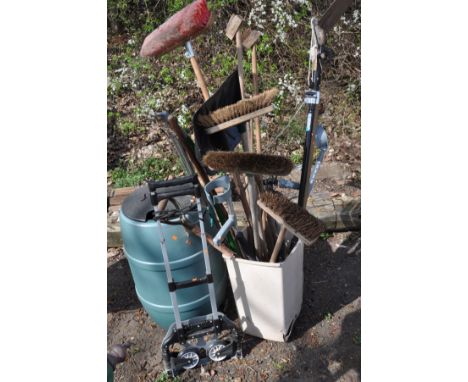 A GREEN WATER BUTT together with a folding sack truck, and a bin containing various garden tools including yard brushes, rake