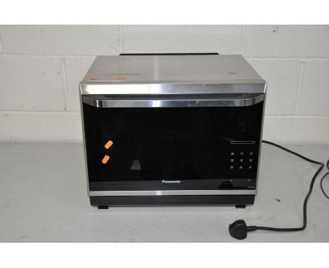 A PANASONIC NN-CF873S THREE IN ONE MICROWAVE, GRILL AND CONVECTION OVEN  with manual 49cm wide 42cm deep (handle extra) 39cm 