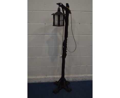 AN OAK STANDARD LAMP with a handing lantern and adjustable support